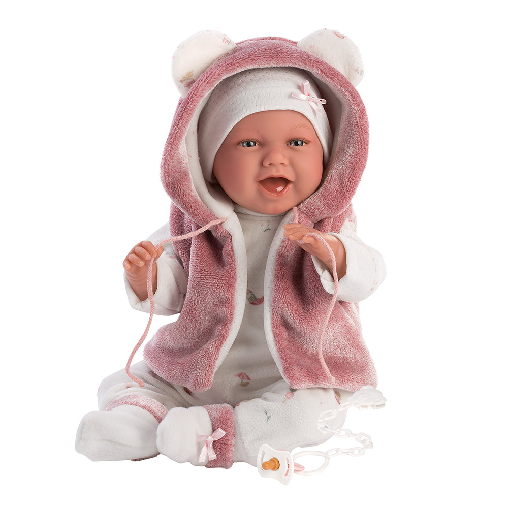 74070 - Mimi Sonrisas: Mimi es un recién nacido que ríe y es la alegría de la casa. Lleva un conjunto blanco y rosa y abrigo con capucha con orejitas.